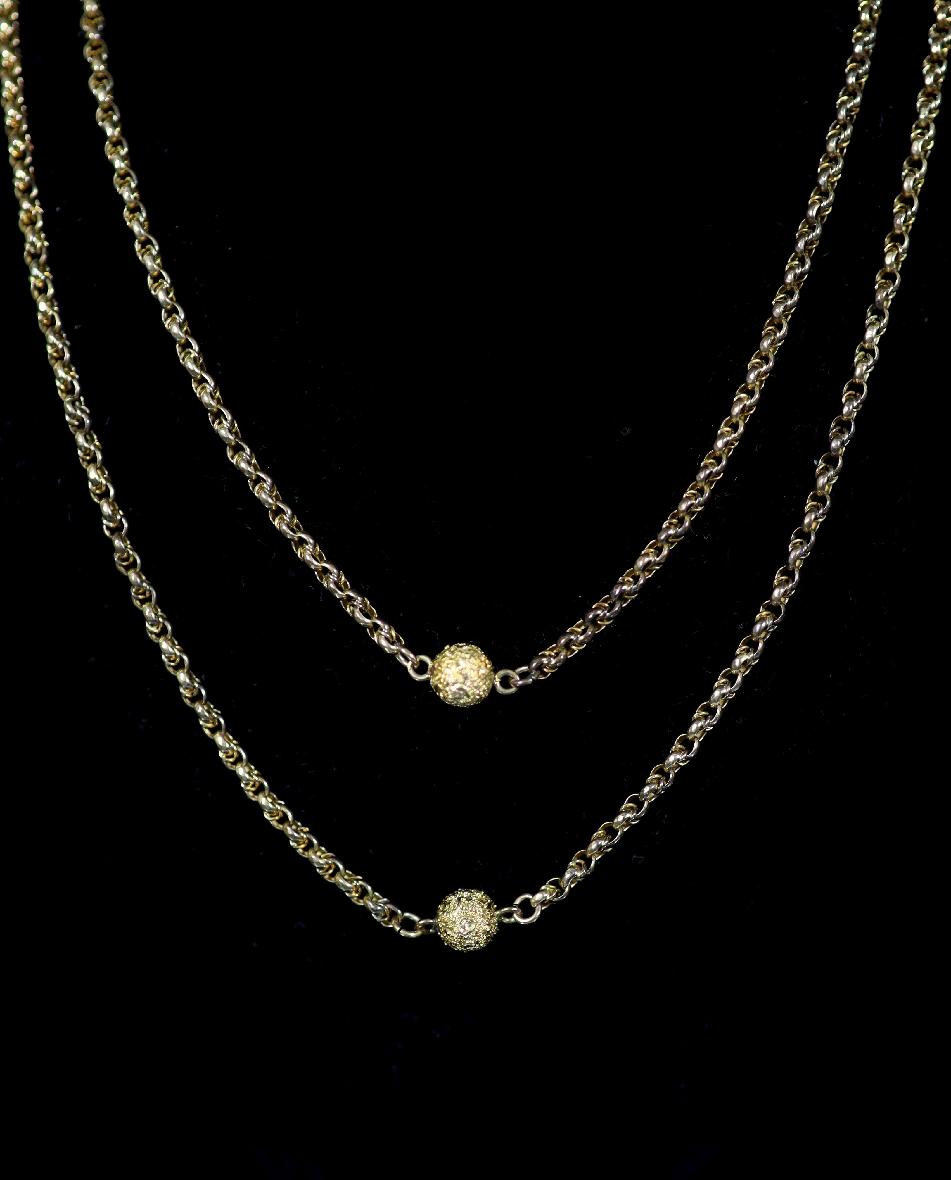 A 19th century 9ct gold guard chain with seven engraved spheres, 124cm